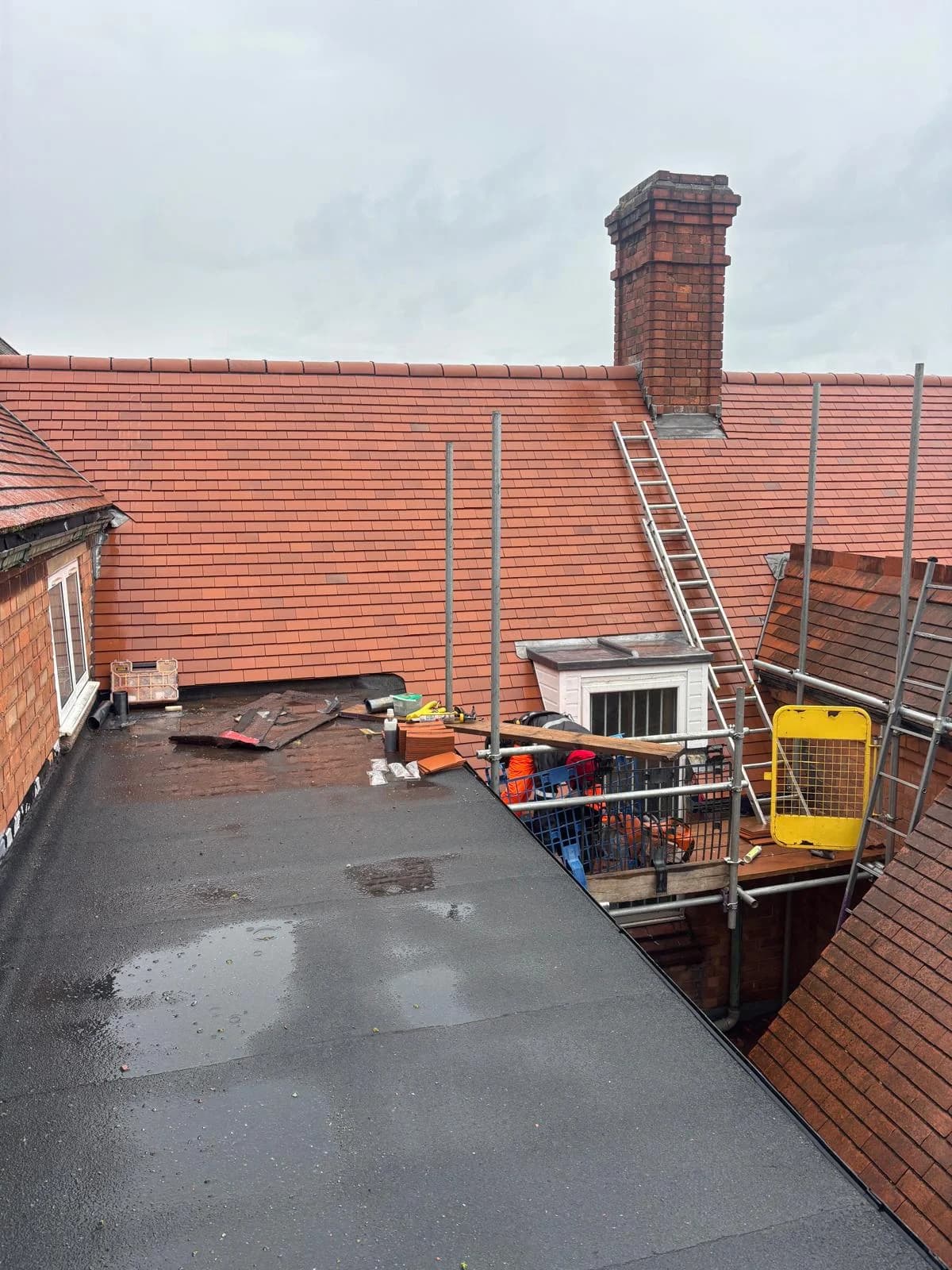 Lead-lined flat roof section and chimney after repair
