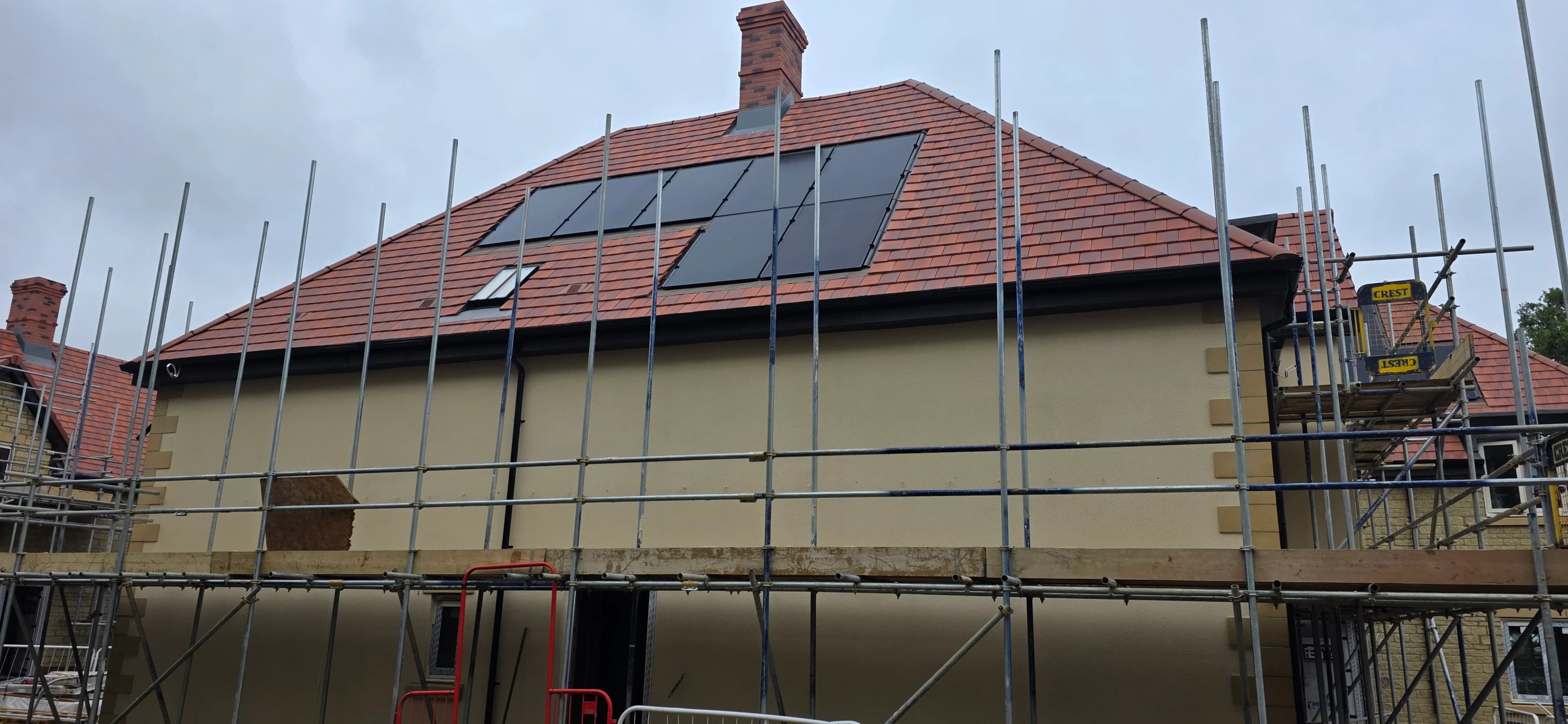 Housing development roofs with solar-ready tiling and scaffolding