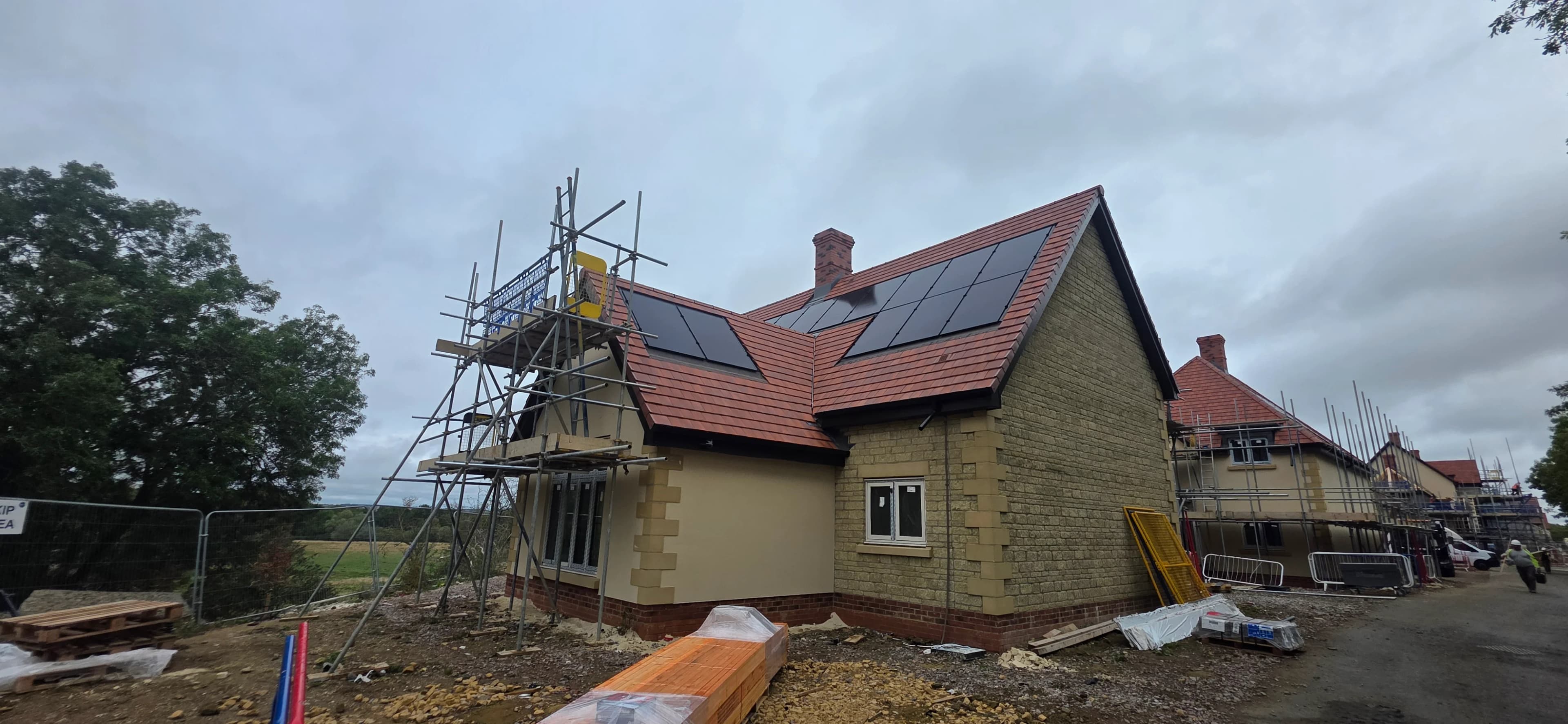 Single-storey building re-roof with scaffolding and solar panels