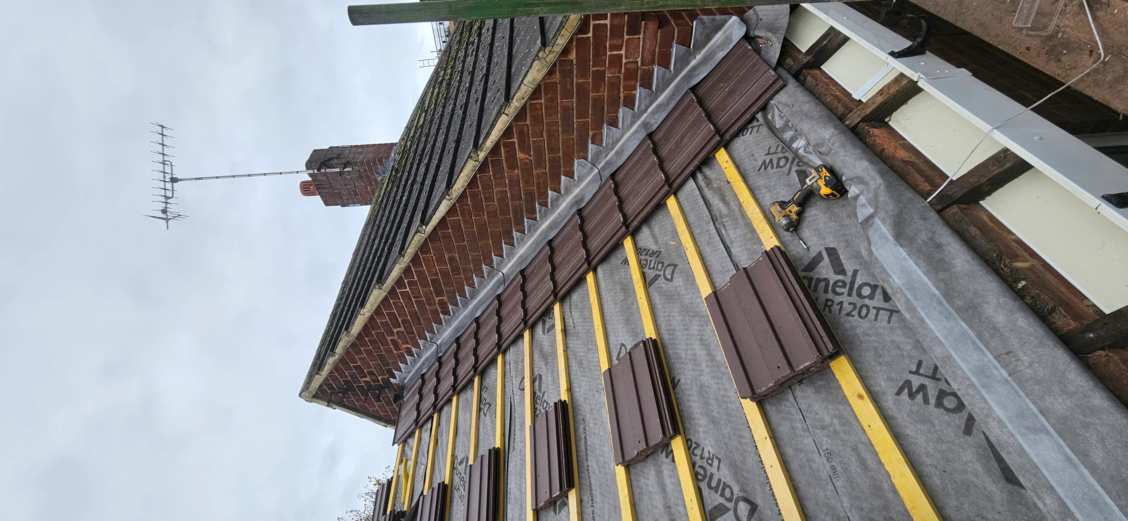 Looking up a slate roof slope with a rooftop aerial