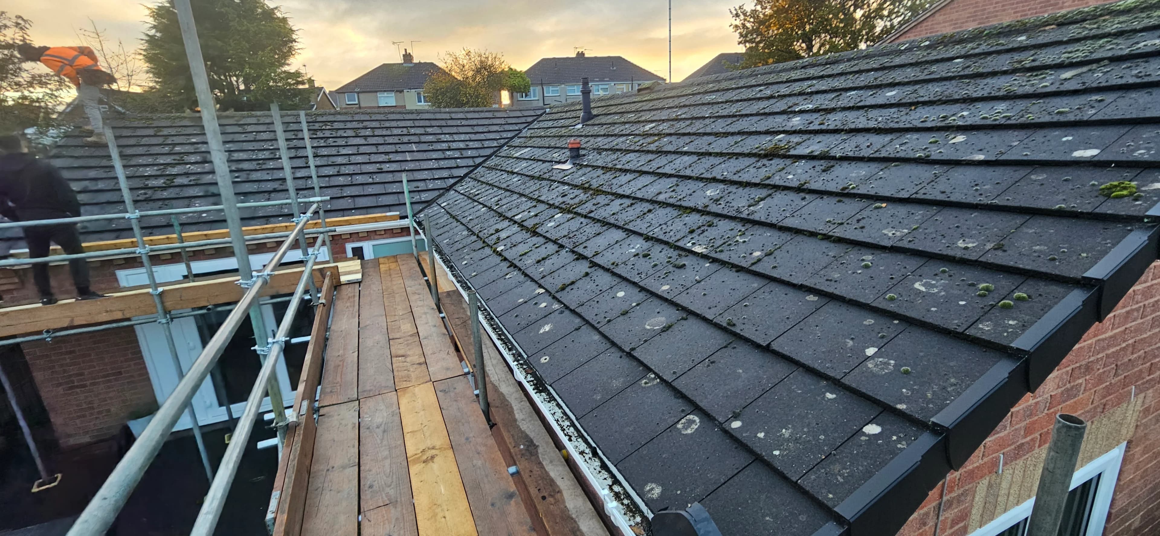 Grey slate roof panorama across a residential property