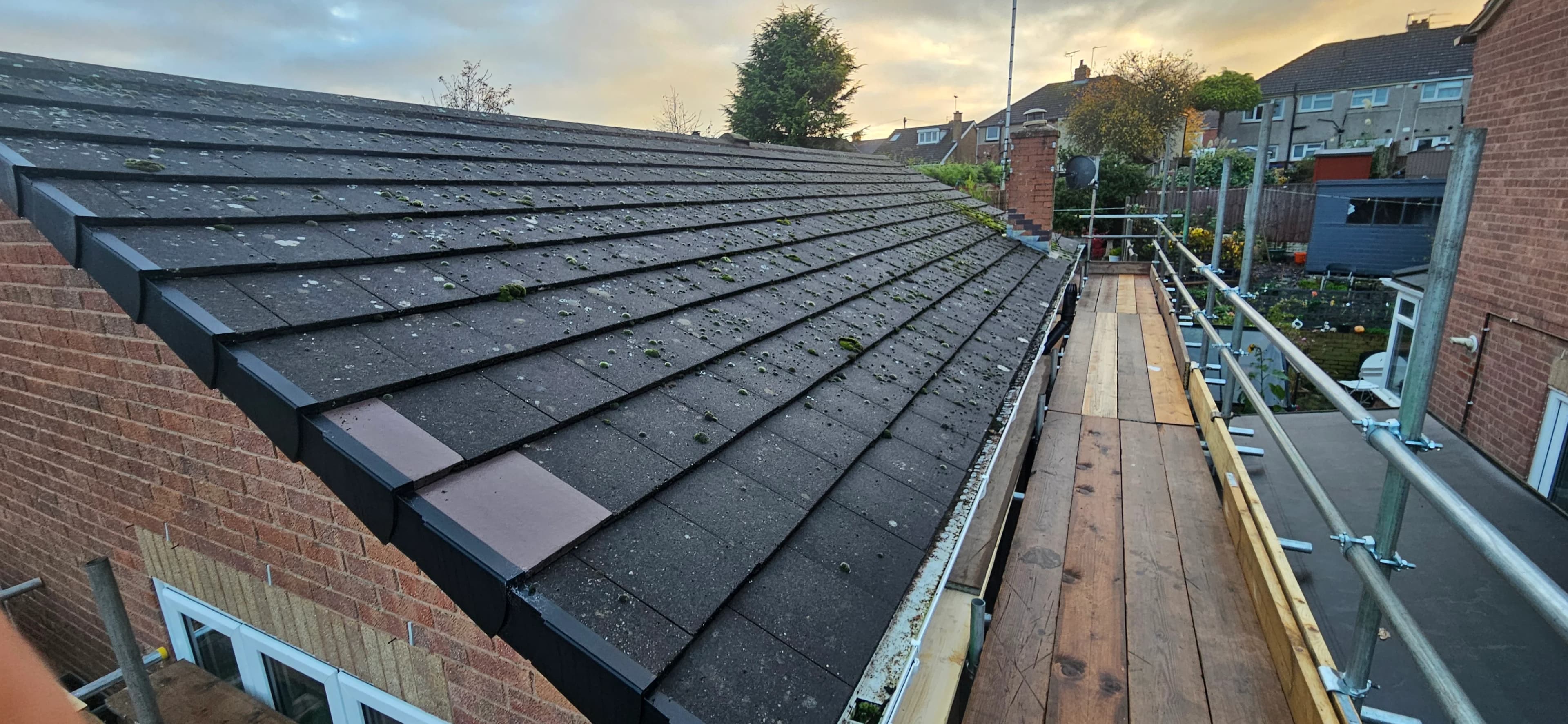 Newly finished grey slate roof with clean ridge line