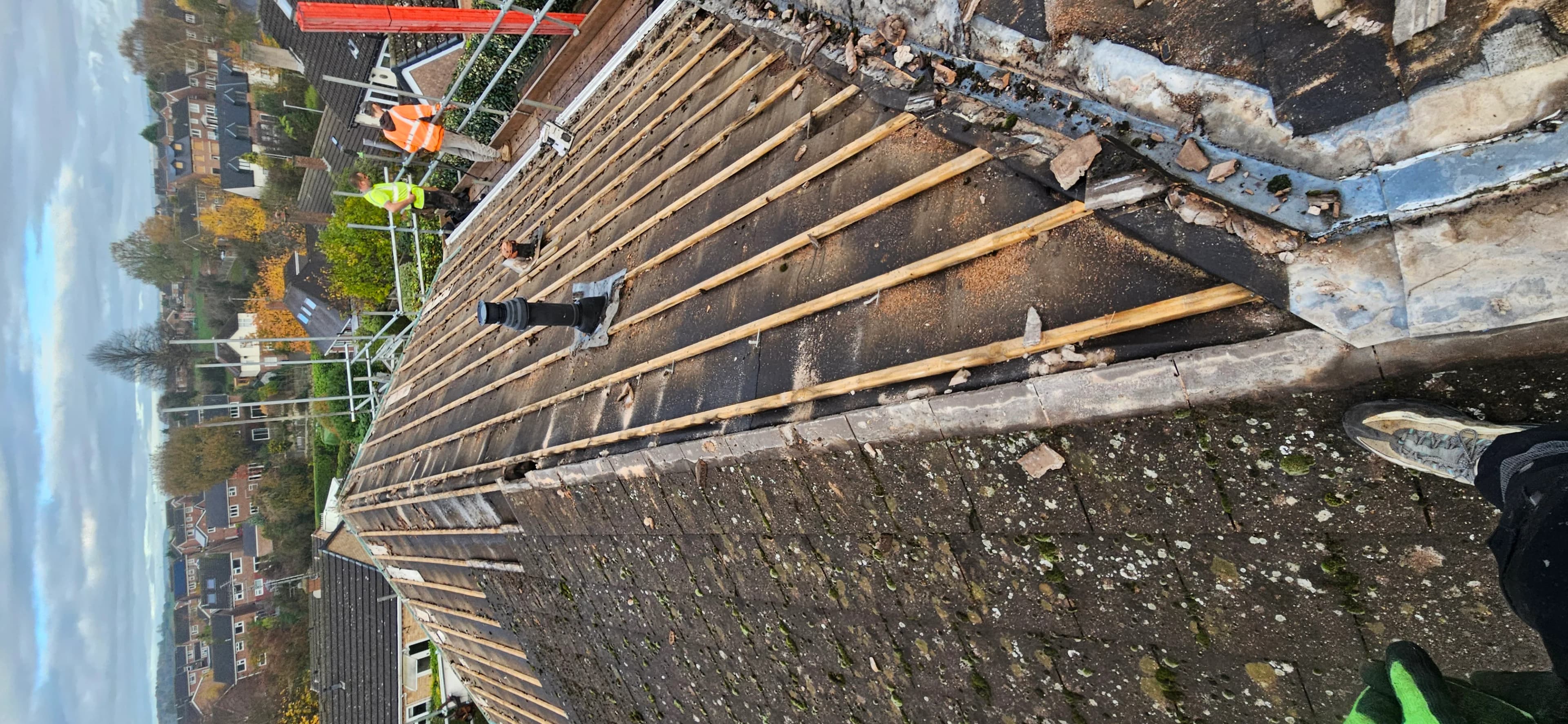 Timber roof structure being rebuilt on a street property