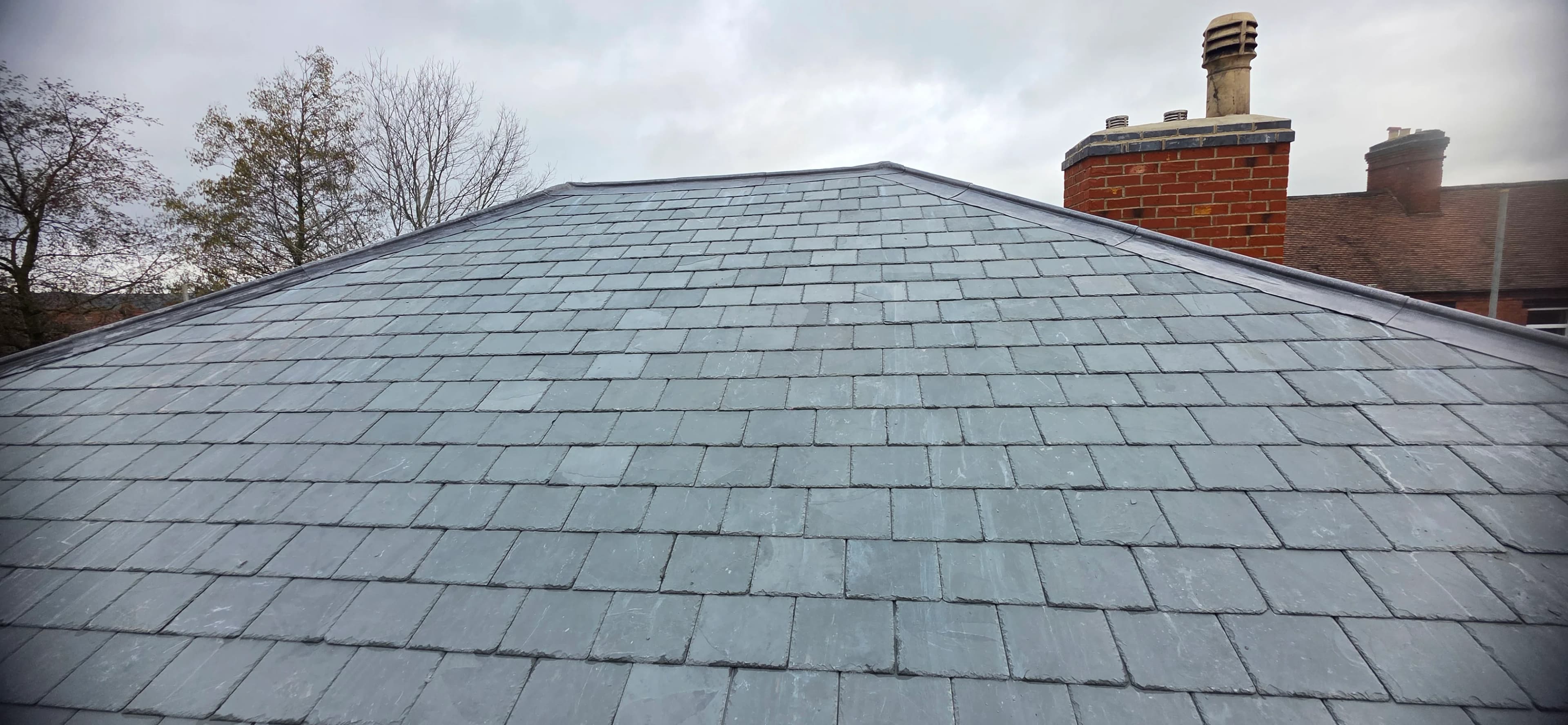 Close view of a finished grey slate roof surface