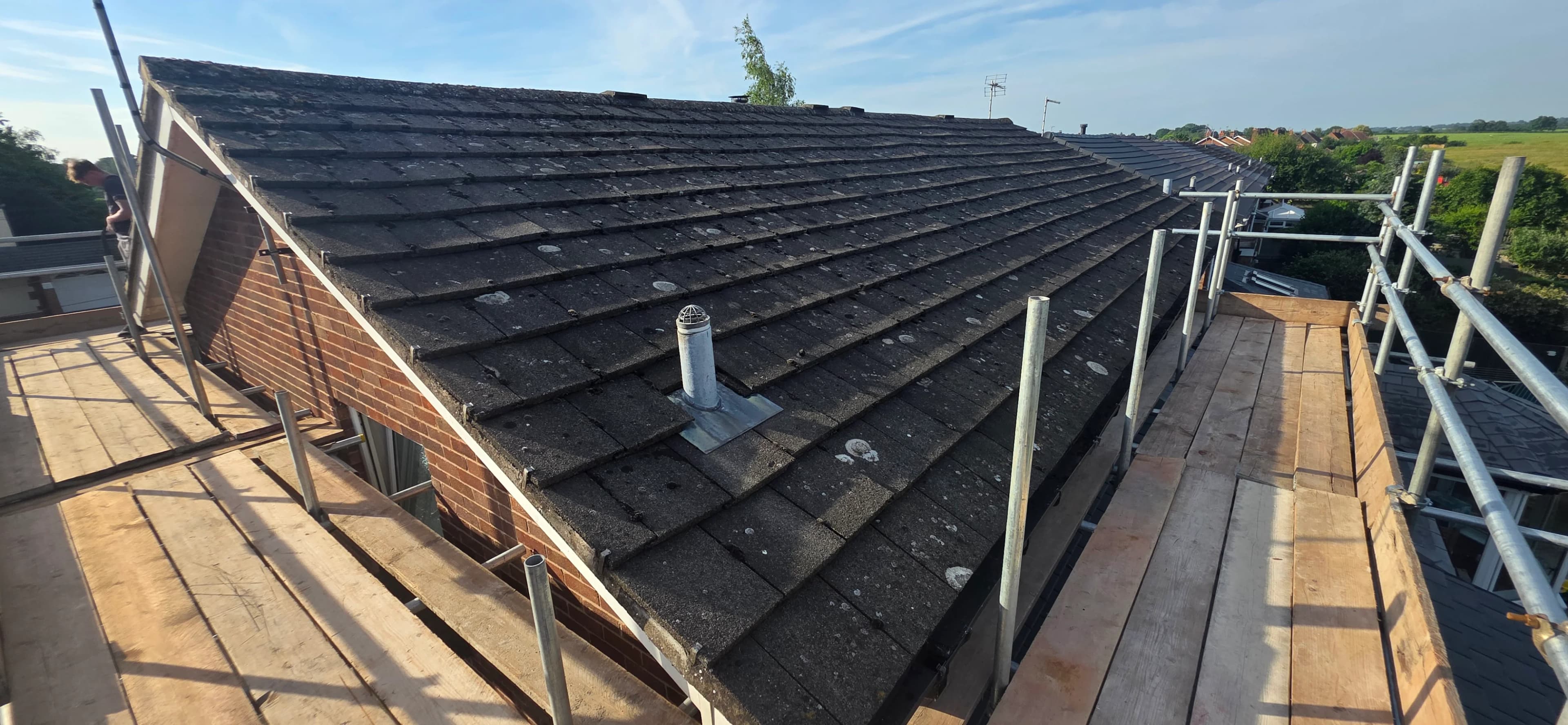 Roof battens and felt being laid ready for new tiles