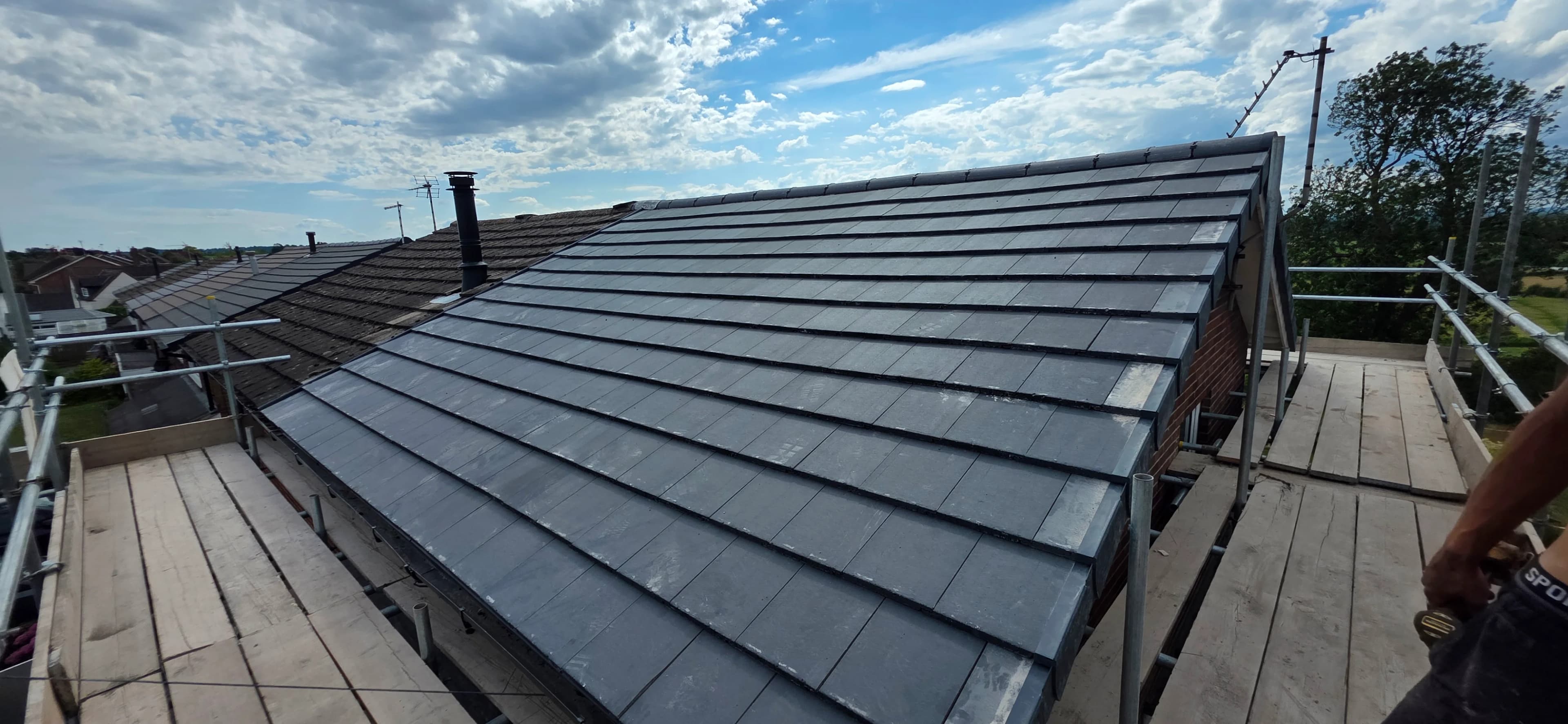 Wide grey slate roof panorama after a re-roof
