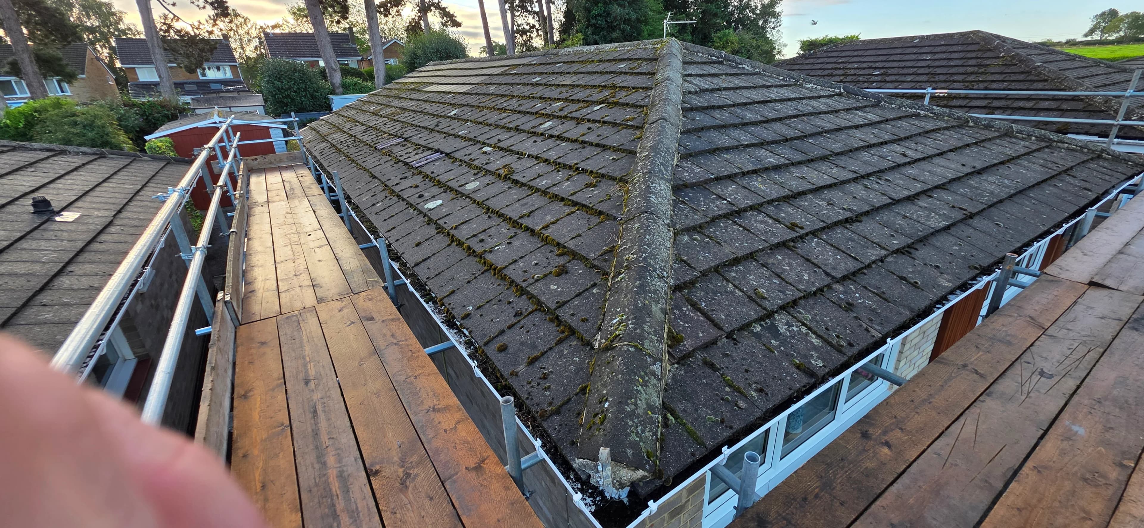 Finished grey tiled hip roof on a detached home