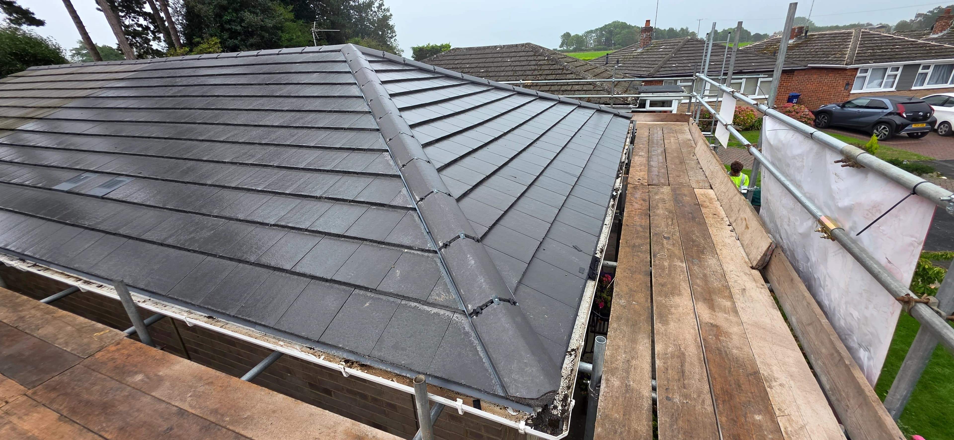 Finished grey slate roof with rooflights and clean valleys